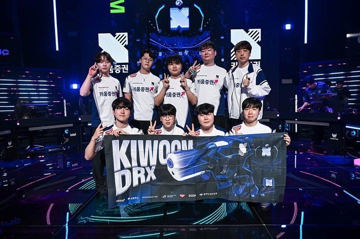 키움증권 유니폼을 입은 키움 DRX 선수들이 무대에서 단체 포즈를 취하고 있다