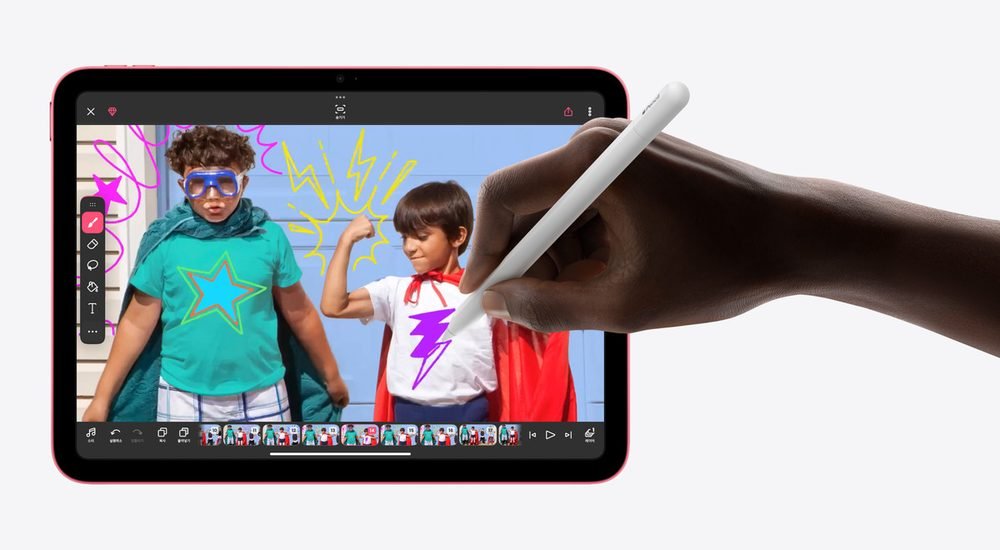 분홍 테두리 아이패드 화면의 아이 사진 위에 손이 흰색 Apple Pencil로 노란 번개 낙서를 그리는 모습